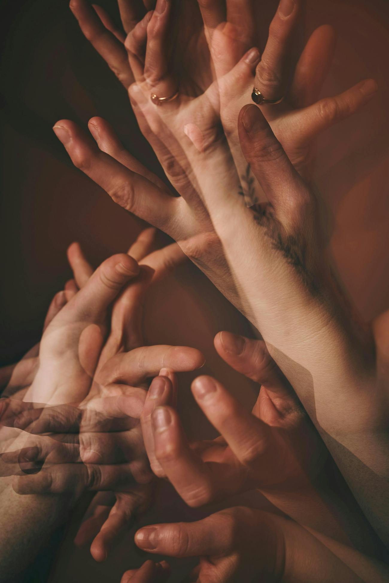 Several photos layered on top of each other of hands doing sign language.
